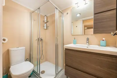 a bathroom with a shower and a toilet and a sink at Stylish Athenian Flat in Athens