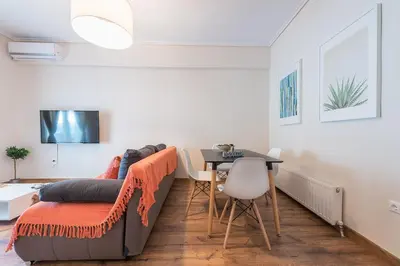 a living room with a couch and a table at Stylish Athenian Flat in Athens