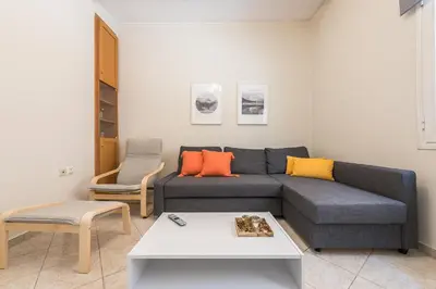 a living room with a couch and a table at Just Under Acropolis in Athens
