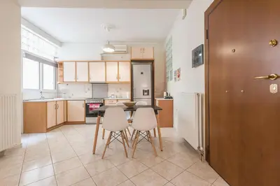 a kitchen with a table and two chairs in it at Just Under Acropolis in Athens