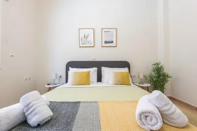 a bedroom with a large bed with towels on it at Just Under Acropolis in Athens