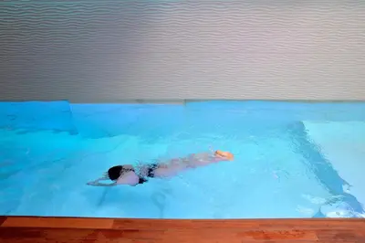 a person swimming in a swimming pool at MIRIVILI hospitality & wellness in Athens
