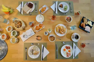 a table topped with plates of breakfast foods at MIRIVILI hospitality & wellness in Athens