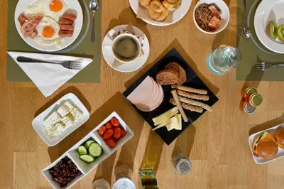 a table with plates of breakfast foods and drinks at MIRIVILI hospitality & wellness in Athens