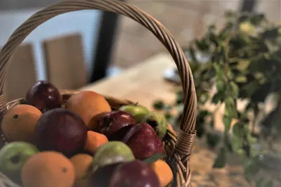 a basket of fruit sitting on top of a table at MIRIVILI hospitality & wellness in Athens