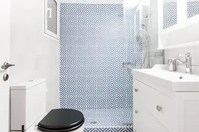 a bathroom with a blue and white patterned shower curtain at Retropolitan Living Athens in Athens