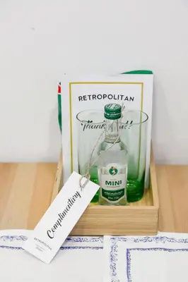 a bottle of whisky in a wooden box with a sign at Retropolitan Living Athens in Athens