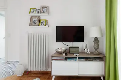 a living room with a tv and a table with a television at Retropolitan Living Athens in Athens