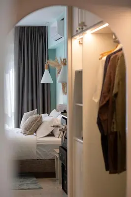 a bedroom with a bed and a room with a closet at The Frogs_Guest House in Athens