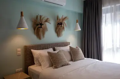 a bedroom with a bed with feathers on the wall at The Frogs_Guest House in Athens