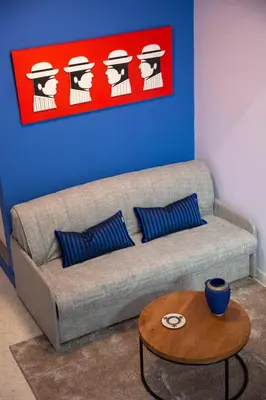 a living room with a couch and a table at The Frogs_Guest House in Athens