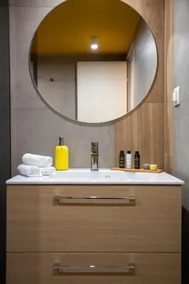 a bathroom with a sink and a mirror at The Frogs_Guest House in Athens