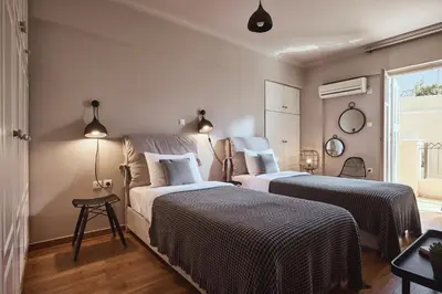 a bedroom with two beds and a window at Plaka's Villa with Breathtaking Acropolis view in Athens