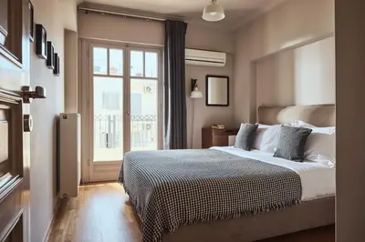 a bedroom with a bed and a large window at Plaka's Villa with Breathtaking Acropolis view in Athens