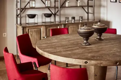 a wooden table with red chairs around it at Plaka's Villa with Breathtaking Acropolis view in Athens