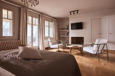 a bedroom with a bed and a living room at Plaka's Villa with Breathtaking Acropolis view in Athens