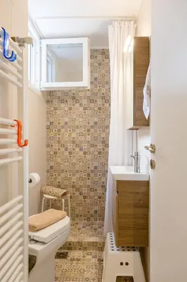a bathroom with a toilet and a sink at Grandma's Chic & Bright Athenian home with a Patio in Athens