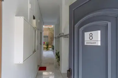a hallway with a blue door with a sign on it at Grandma's Chic & Bright Athenian home with a Patio in Athens