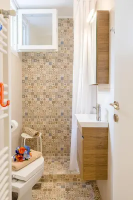 a bathroom with a sink and a toilet and a mirror at Grandma's Chic & Bright Athenian home with a Patio in Athens