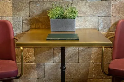 a table with a plant sitting on top of it at Estia Boutique Apartments in Athens