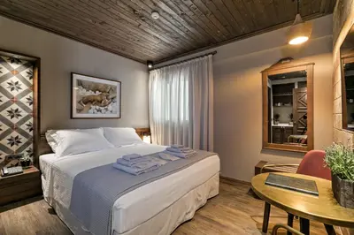 a hotel room with a bed and a table and a table sidx sidx at Estia Boutique Apartments in Athens