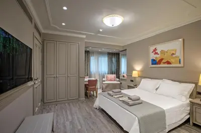 a hotel room with a bed and a chair at Estia Boutique Apartments in Athens