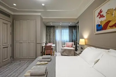 a hotel room with a bed and a chair at Estia Boutique Apartments in Athens