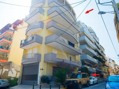 a yellow truck parked in front of a building at 7th Floor Stunning View Penthouse in Piraeus in Piraeus