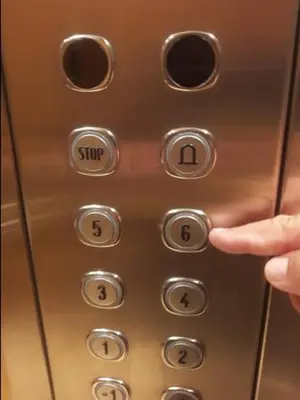 a person pressing the stop button on a remote control at 7th Floor Stunning View Penthouse in Piraeus in Piraeus