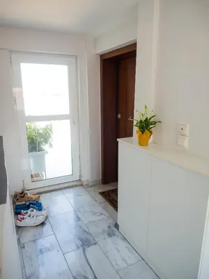 a kitchen with a window and a tile floor at 7th Floor Stunning View Penthouse in Piraeus in Piraeus