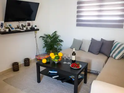 a living room with a couch and a table with wine glasses at 7th Floor Stunning View Penthouse in Piraeus in Piraeus