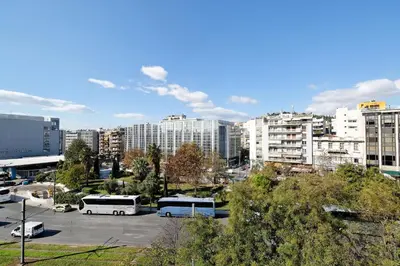two buses parked in a parking lot in a city at Athens Heartbeat in Athens