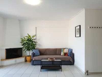 a living room with a couch and a fireplace at KYMA Apartments - Athens Acropolis 14 in Athens