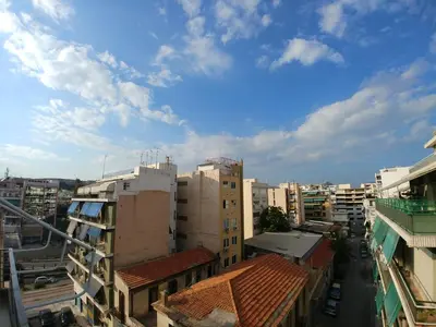 a view of a city with buildings and a blue sky at KYMA Apartments - Athens Acropolis 14 in Athens