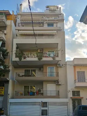 an apartment building with two balconies and a garage at KYMA Apartments - Athens Acropolis 14 in Athens