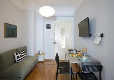 a living room with a couch and a table at Attractive Flat near the Acropolis Museum & Metro Station by Athenian Homes in Athens