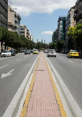 a city street with cars driving down a road at Attractive Flat near the Acropolis Museum & Metro Station by Athenian Homes in Athens