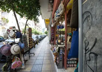 a street with a shop with hats and other merchandise at Attractive Flat near the Acropolis Museum & Metro Station by Athenian Homes in Athens