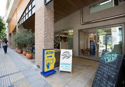 a store with signs in front of a building at Attractive Flat near the Acropolis Museum & Metro Station by Athenian Homes in Athens
