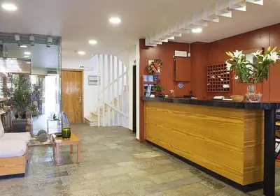 a lobby with a bar and a living room at Stefanakis Hotel & Apartments in Varkiza