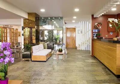 a living room with a couch and a table at Stefanakis Hotel & Apartments in Varkiza