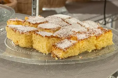 a glass plate with four pieces of cake with powdered sugar at Hotel @Syngrou Fix in Athens