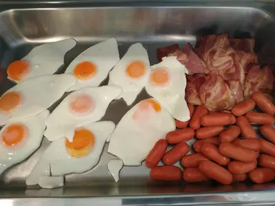 a tray filled with eggs and beans and bacon at Hotel @Syngrou Fix in Athens