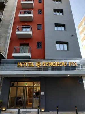 a hotel sign on the front of a building at Hotel @Syngrou Fix in Athens