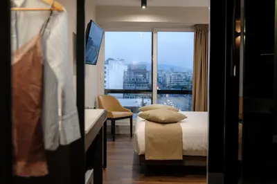 a hotel room with a bed and a large window at B4B Athens 365 in Athens