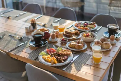 a table topped with plates of food and drinks at B4B Athens 365 in Athens