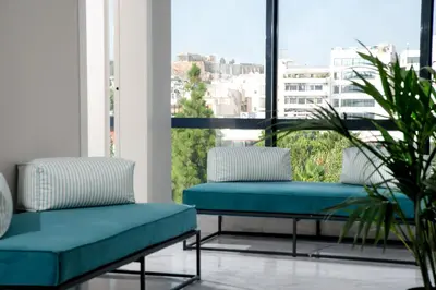 two benches on a balcony with a view of a city at B4B Athens 365 in Athens