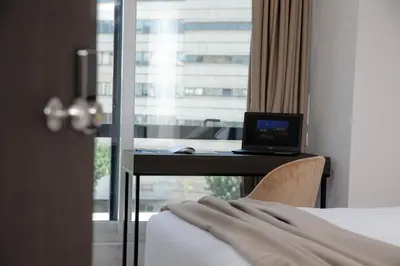 a hotel room with a desk with a laptop on it at B4B Athens 365 in Athens