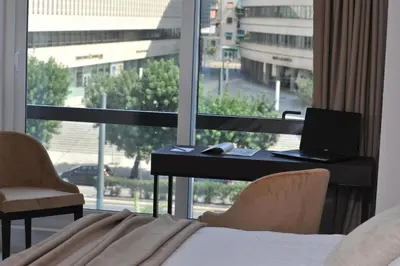 a bedroom with a desk with a laptop and a window at B4B Athens 365 in Athens