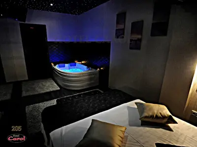 a room with a bath tub and a bed and a bed sidx sidx at Carol Hotel in Piraeus